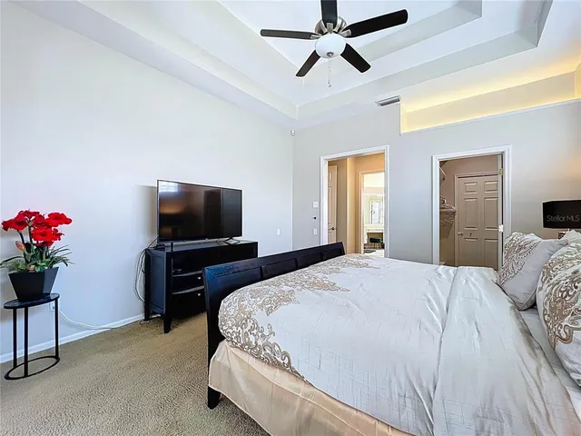 a bathroom with a sink a toilet a mirror and shower