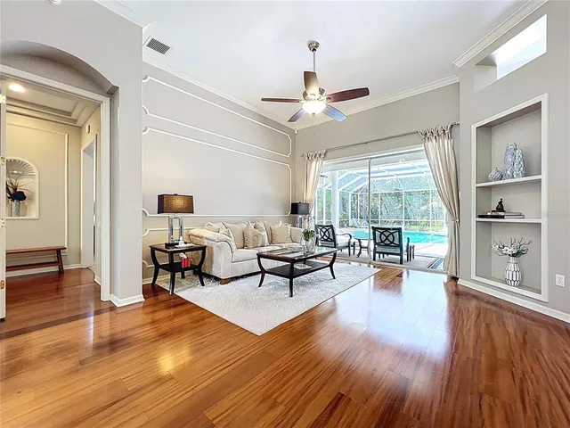 a living room with furniture a table and chairs