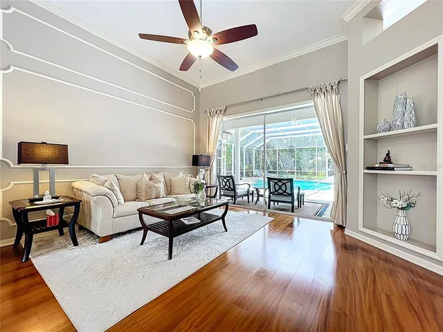 a kitchen with stainless steel appliances granite countertop a table chairs microwave and sink