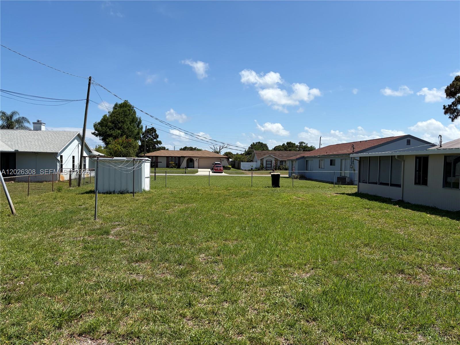 653 Atlas Avenue Northeast Palm Bay, FL 32905 - Photo 22 of 22 a backyard of a house with table and chairs