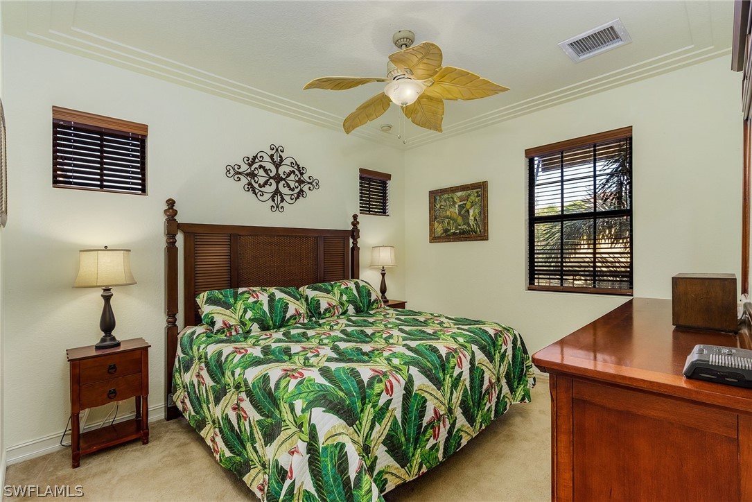 11947 Tulio Way, Unit 4002 Fort Myers, FL 33912 - Photo 11 of 26 a bed sitting in a bedroom next to a window