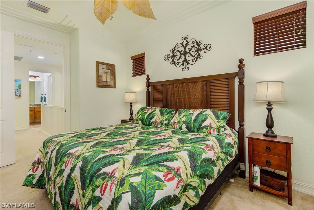 11947 Tulio Way, Unit 4002 Fort Myers, FL 33912 - Photo 12 of 26 a bedroom with a bed and a lamp on dresser