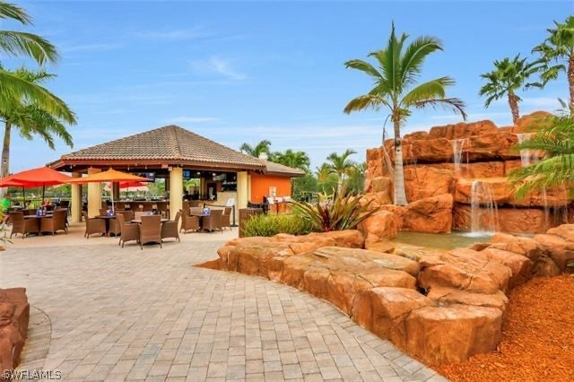 11947 Tulio Way, Unit 4002 Fort Myers, FL 33912 - Photo 21 of 26 a view of a house with swimming pool and sitting area
