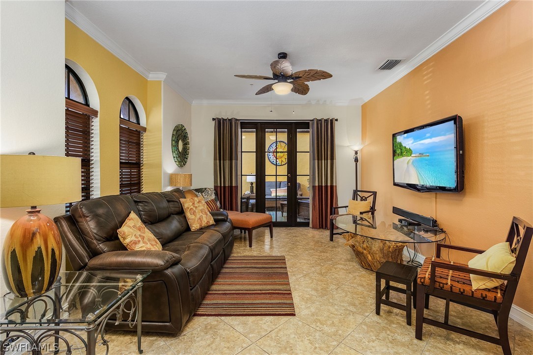 11947 Tulio Way, Unit 4002 Fort Myers, FL 33912 - Photo 3 of 26 a living room with furniture and a flat screen tv