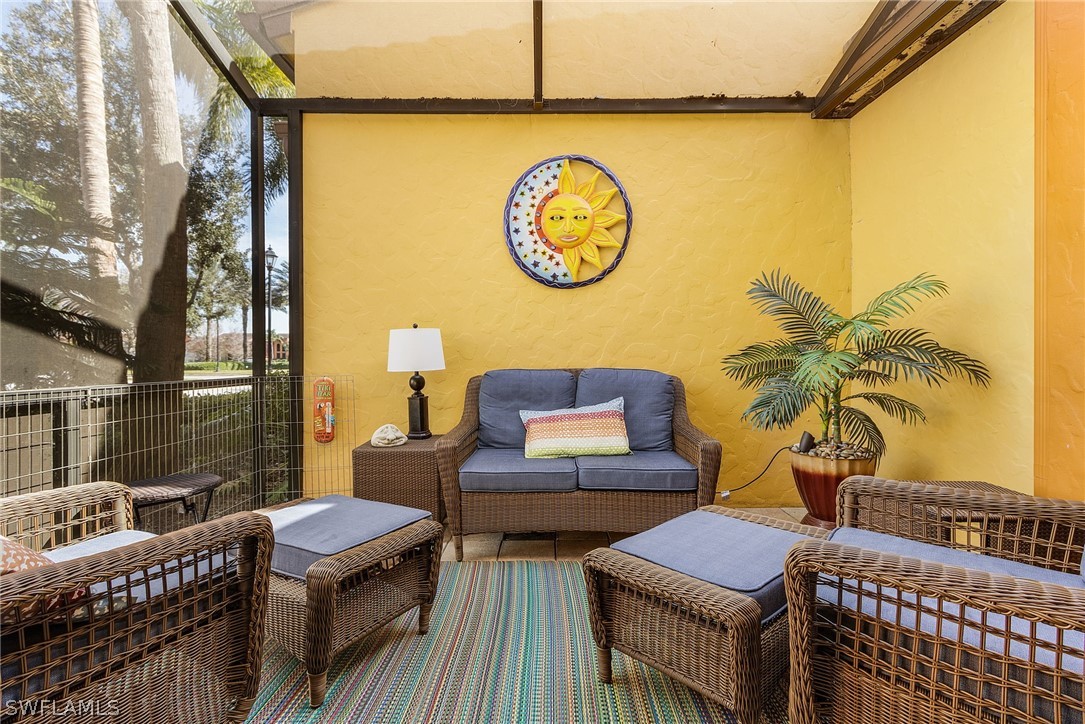 11947 Tulio Way, Unit 4002 Fort Myers, FL 33912 - Photo 9 of 26 a living room with furniture a wall clock and a potted plant