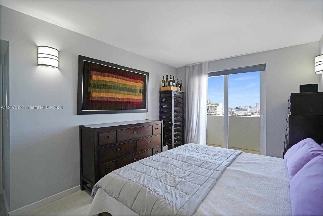 1621 Bay Road, Unit PH1 Miami Beach, FL 33139 - Photo 15 of 32 a bedroom with a bed and a dresser
