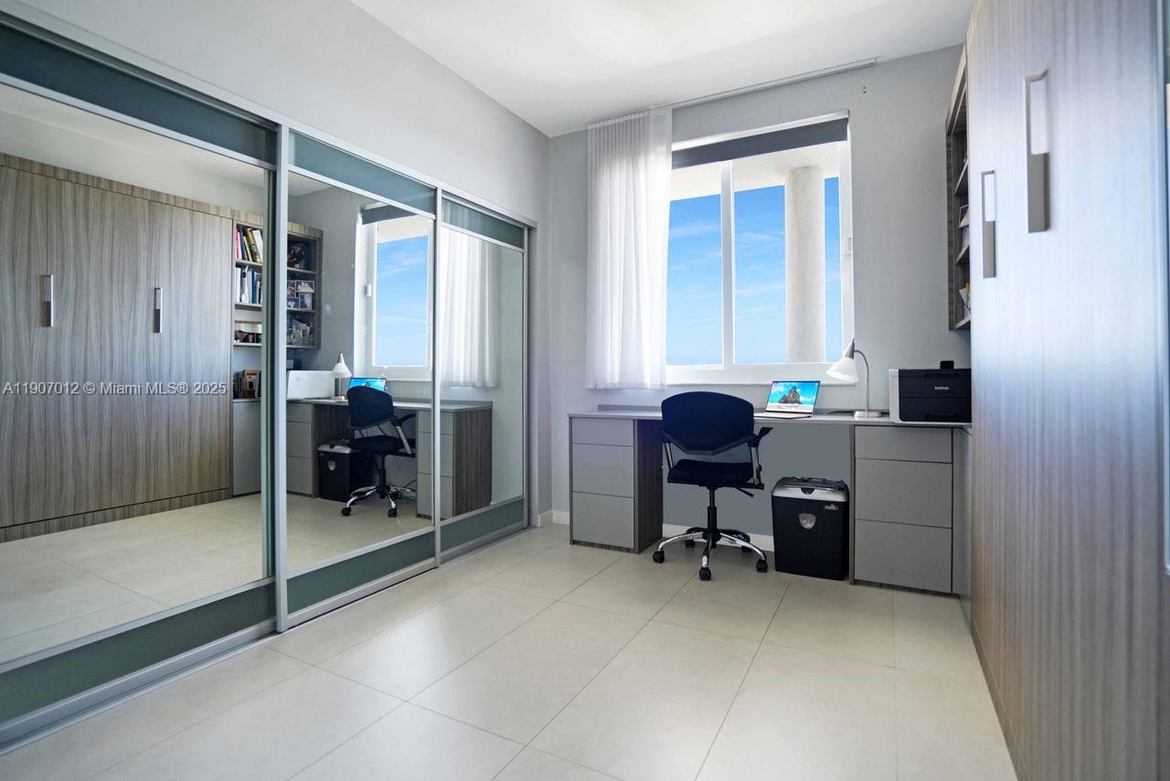 1621 Bay Road, Unit PH1 Miami Beach, FL 33139 - Photo 17 of 32 a view of a workspace with furniture and a window