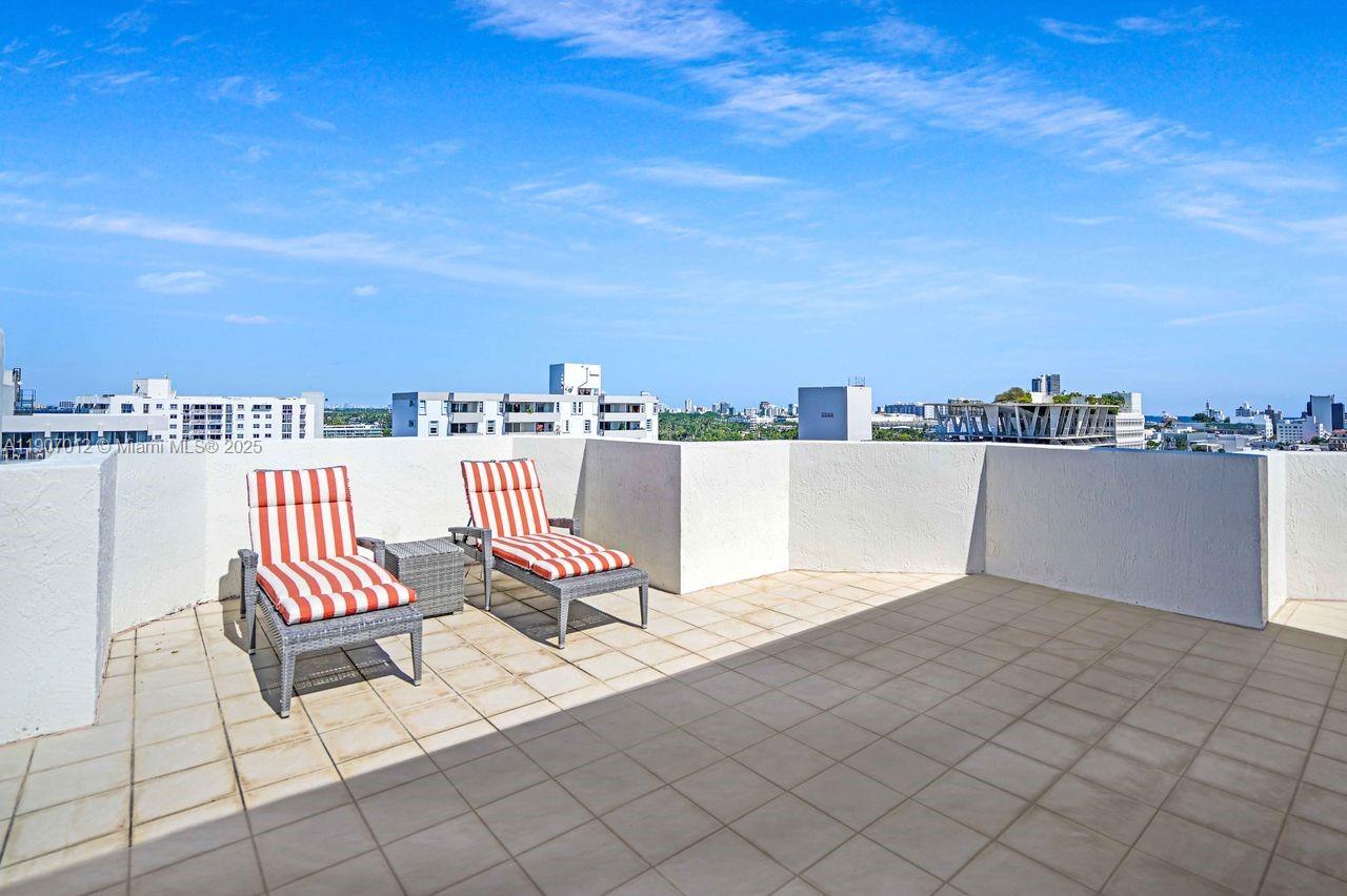 1621 Bay Road, Unit PH1 Miami Beach, FL 33139 - Photo 5 of 32 a view of roof deck with two chairs and a table