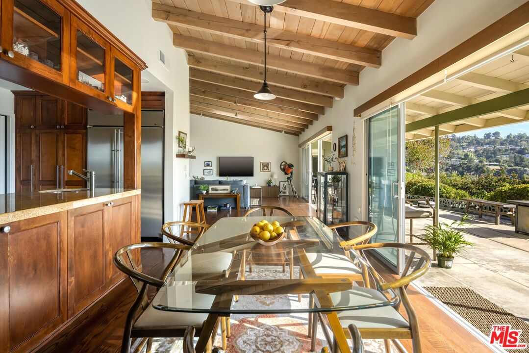 3823 Cody Road Sherman Oaks, CA 91403 - Photo 17 of 38 a view of a dining room with furniture wooden floor and a chandelier