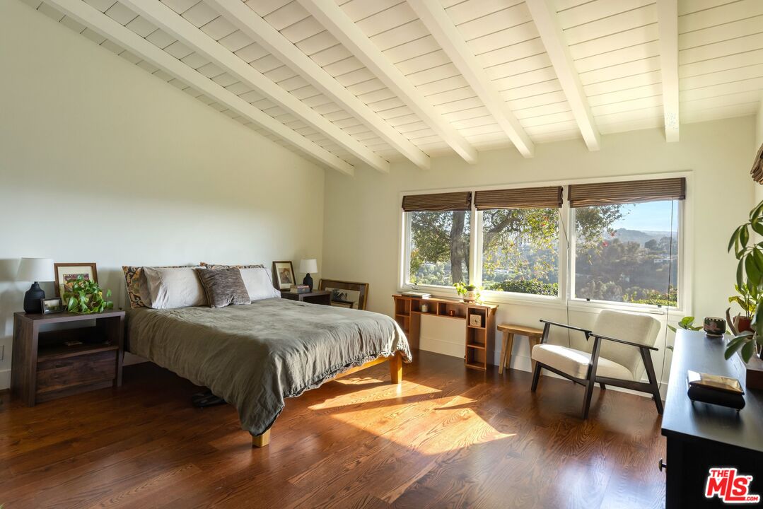 3823 Cody Road Sherman Oaks, CA 91403 - Photo 19 of 38 a spacious bedroom with a bed and a large window