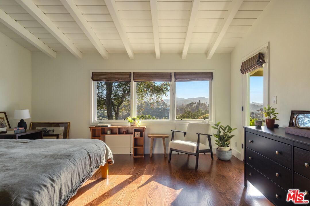 3823 Cody Road Sherman Oaks, CA 91403 - Photo 20 of 38 a bedroom with a bed and a large window