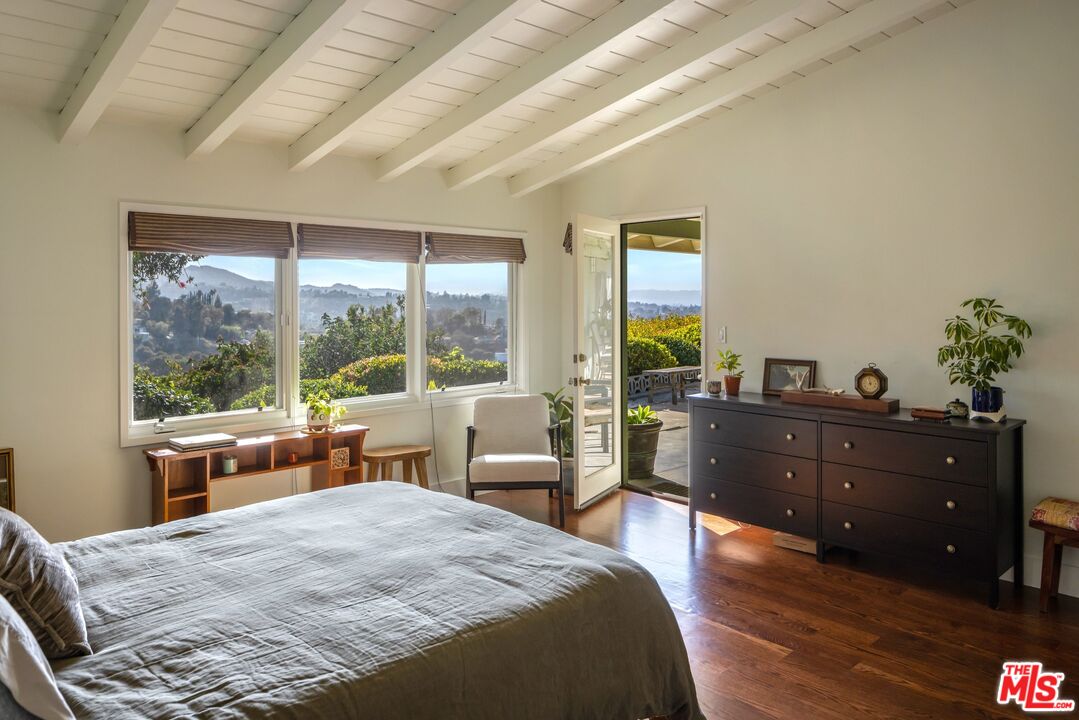 3823 Cody Road Sherman Oaks, CA 91403 - Photo 21 of 38 a bed room with a bed and a large window