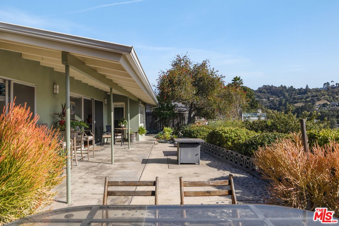 3823 Cody Road Sherman Oaks, CA 91403 - Photo 29 of 38 a view of the patio with couches and table and chairs and potted plants
