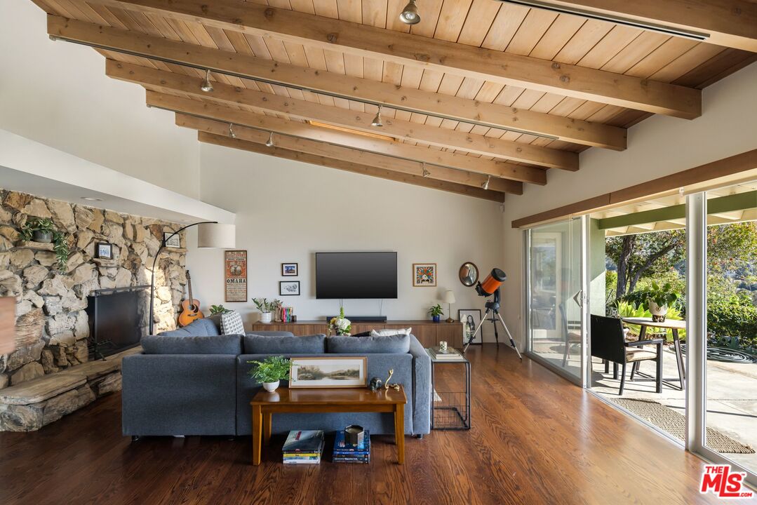 3823 Cody Road Sherman Oaks, CA 91403 - Photo 6 of 38 a living room with furniture a fireplace and a flat screen tv