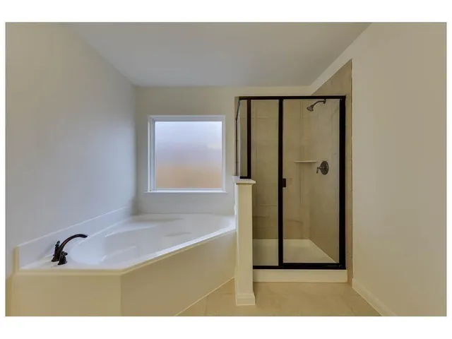 a bathroom with a granite countertop sink a mirror and shower