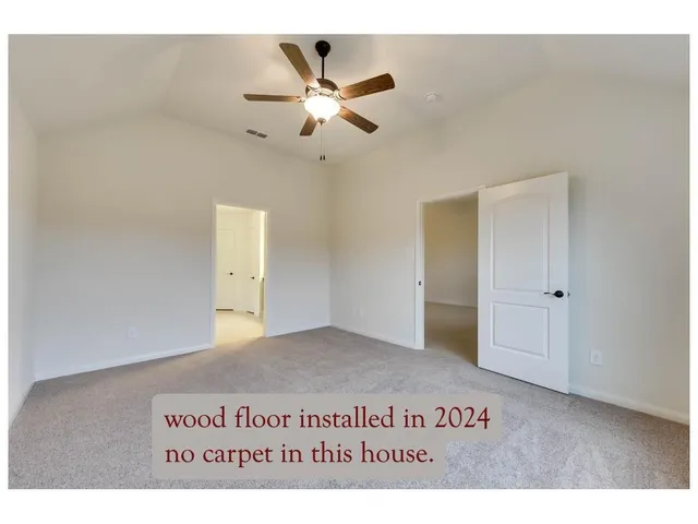a view of a ceiling fan in a hallway
