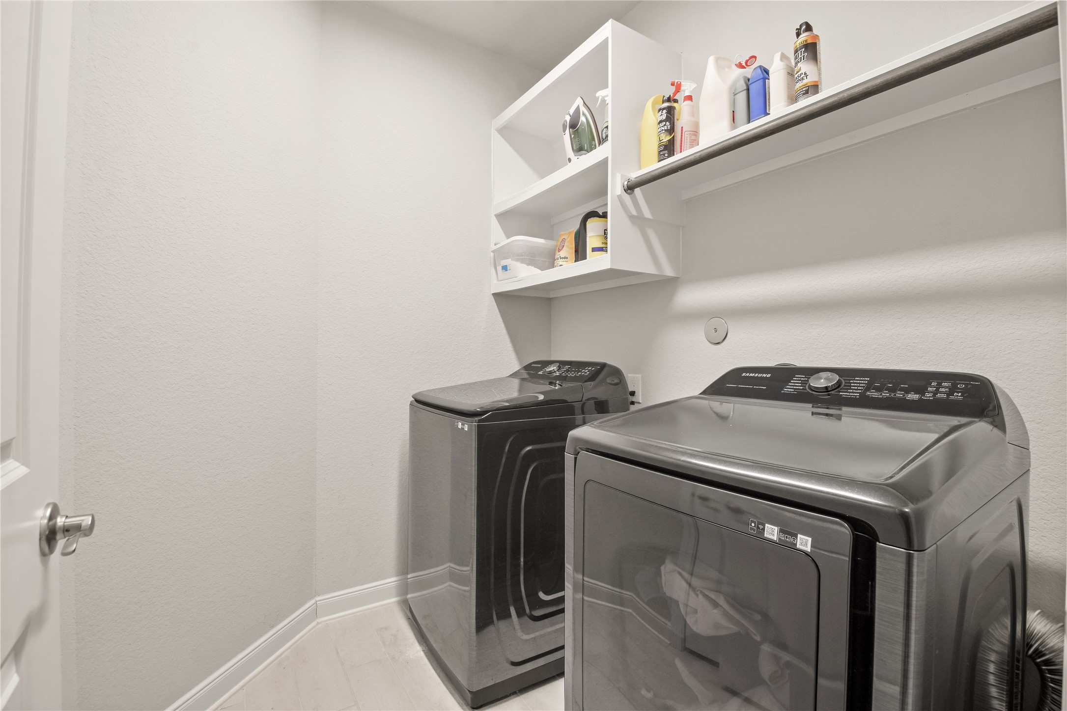 24727 Horsetooth Dr Spring Spring, TX 77373 - Photo 20 of 27 A dedicated laundry space with storage and modern appliances makes household tasks a breeze. Everything you need, neatly tucked away for effortless living.