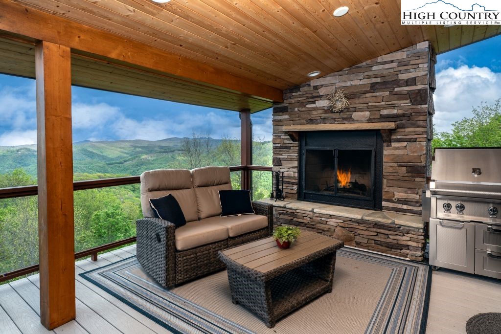 331 May Apple Trail Newland, NC 28657 - Photo 17 of 48 a living room with furniture a fireplace and a floor to ceiling window