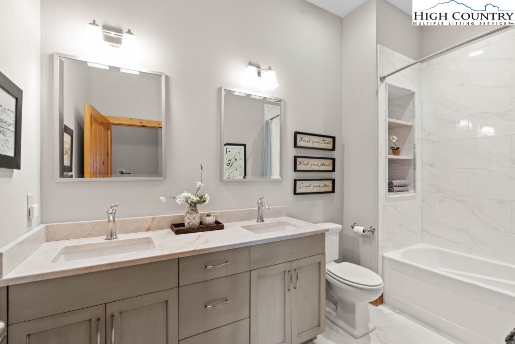 331 May Apple Trail Newland, NC 28657 - Photo 19 of 48 a bathroom with a toilet a sink a large mirror and shower