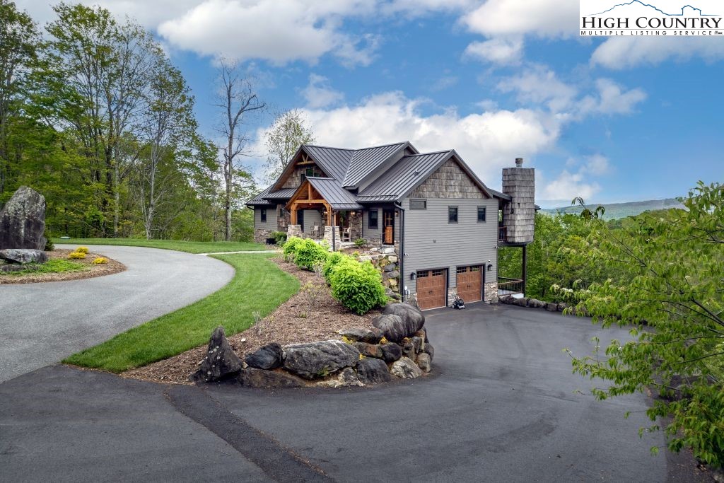 331 May Apple Trail Newland, NC 28657 - Photo 39 of 48 a front view of a house with a garden and trees