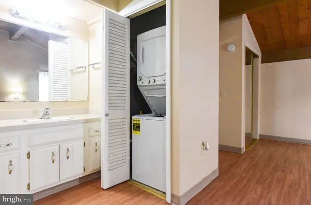 a bathroom with a sink a mirror and a window