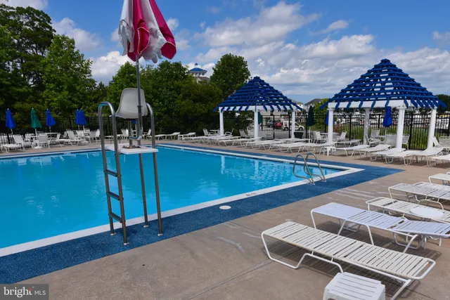 a swimming pool with outdoor seating and yard