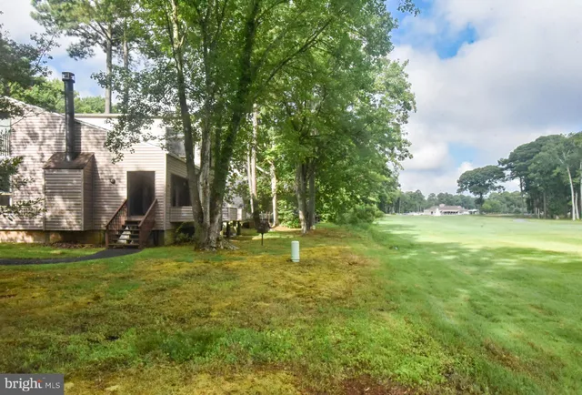 a swimming pool with outdoor seating and yard
