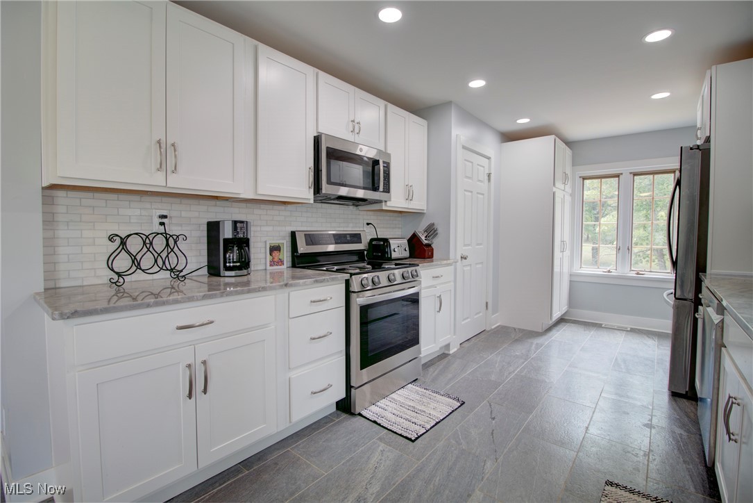 311 Hillside Road Independence, OH 44131 - Photo 2 of 46 Tiled dining space with sink and a textured ceiling