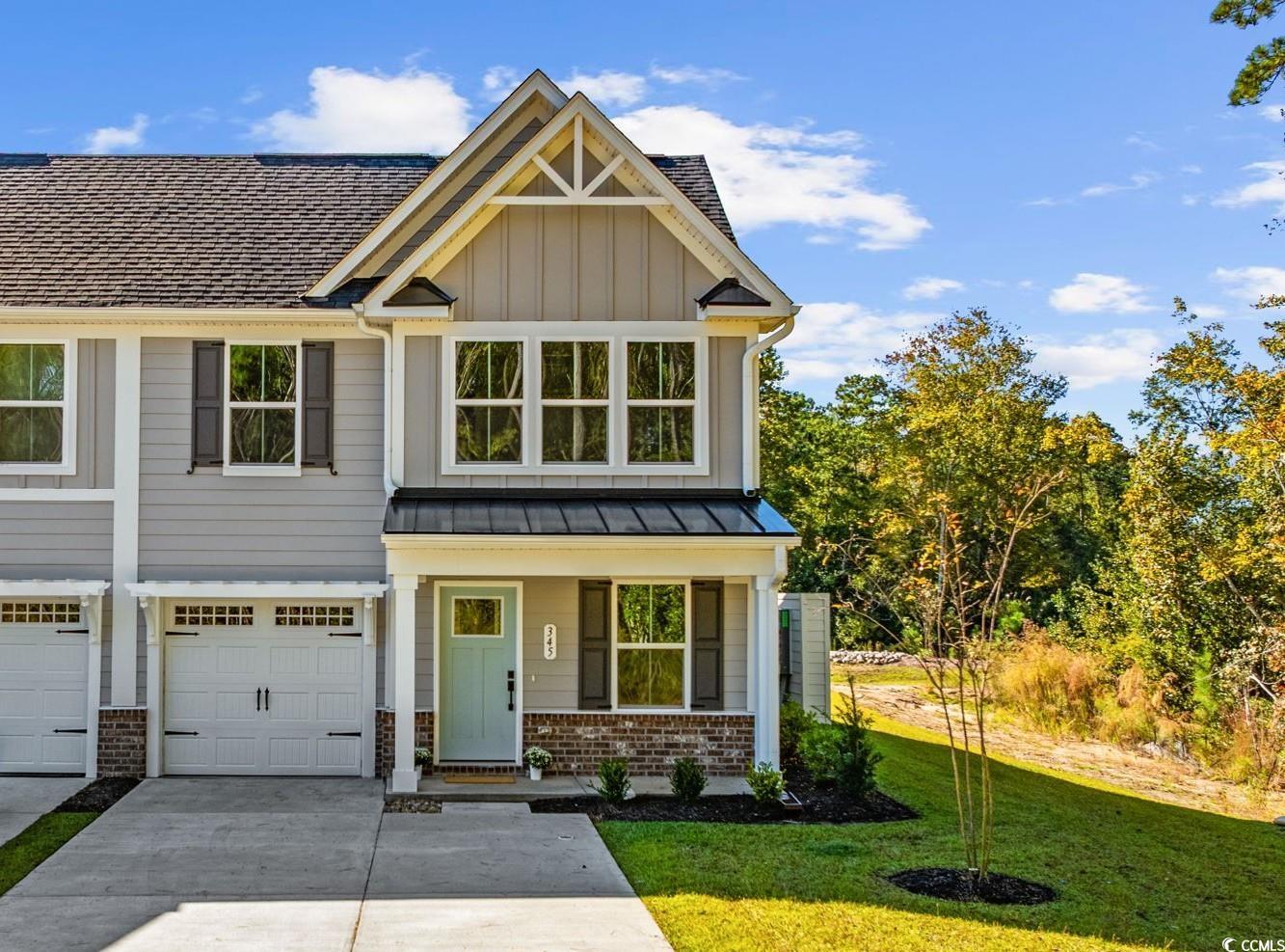345 Bent Green, Unit 90A Murrells Inlet, SC 29576 - Photo 1 of 39 Craftsman-style home featuring covered porch, a front lawn, board and batten siding, concrete driveway, and an attached garage
