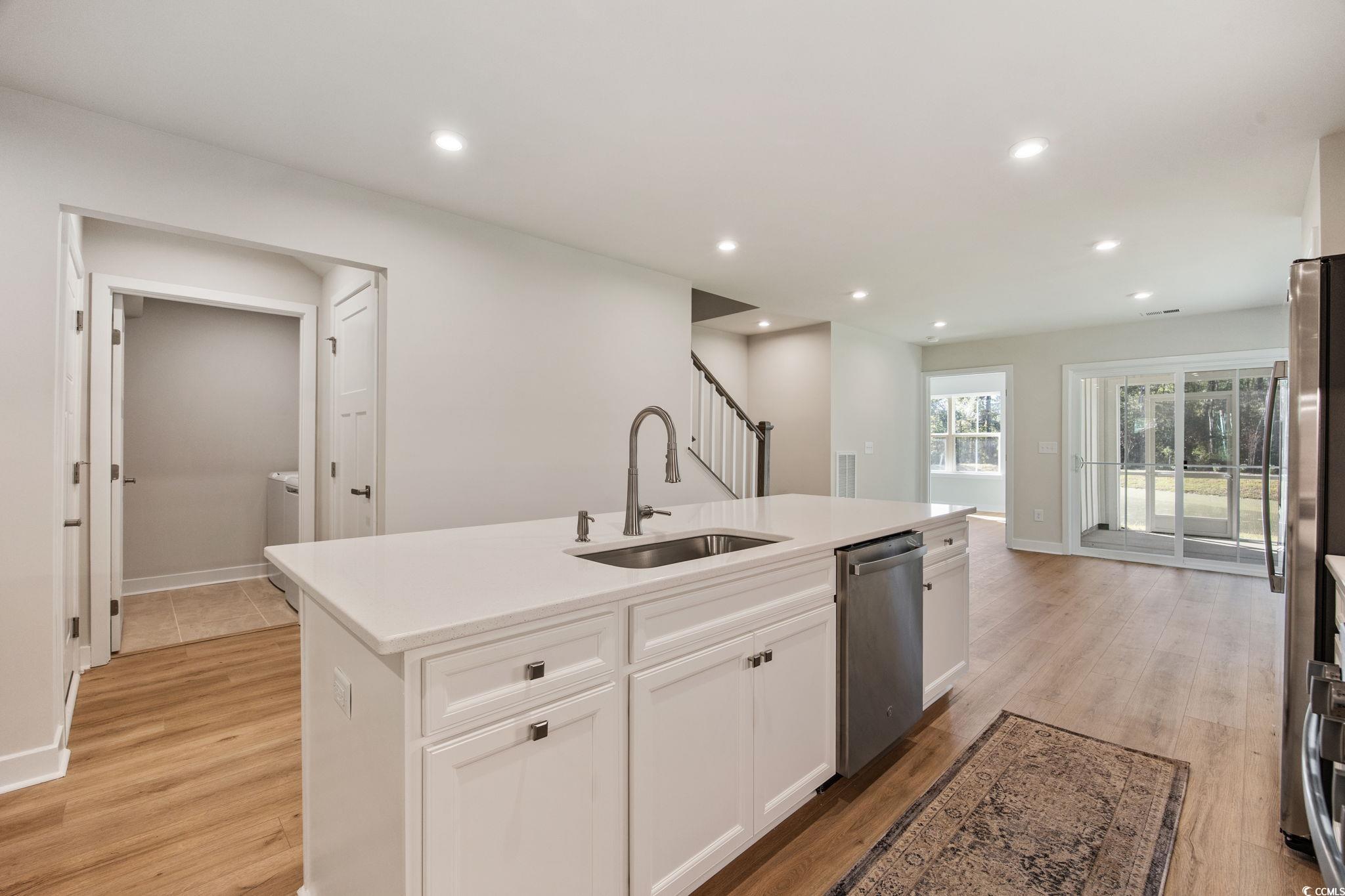345 Bent Green, Unit 90A Murrells Inlet, SC 29576 - Photo 11 of 39 Kitchen featuring white cabinets, recessed lighting, a center island with sink, light stone counters, and light wood-style floors