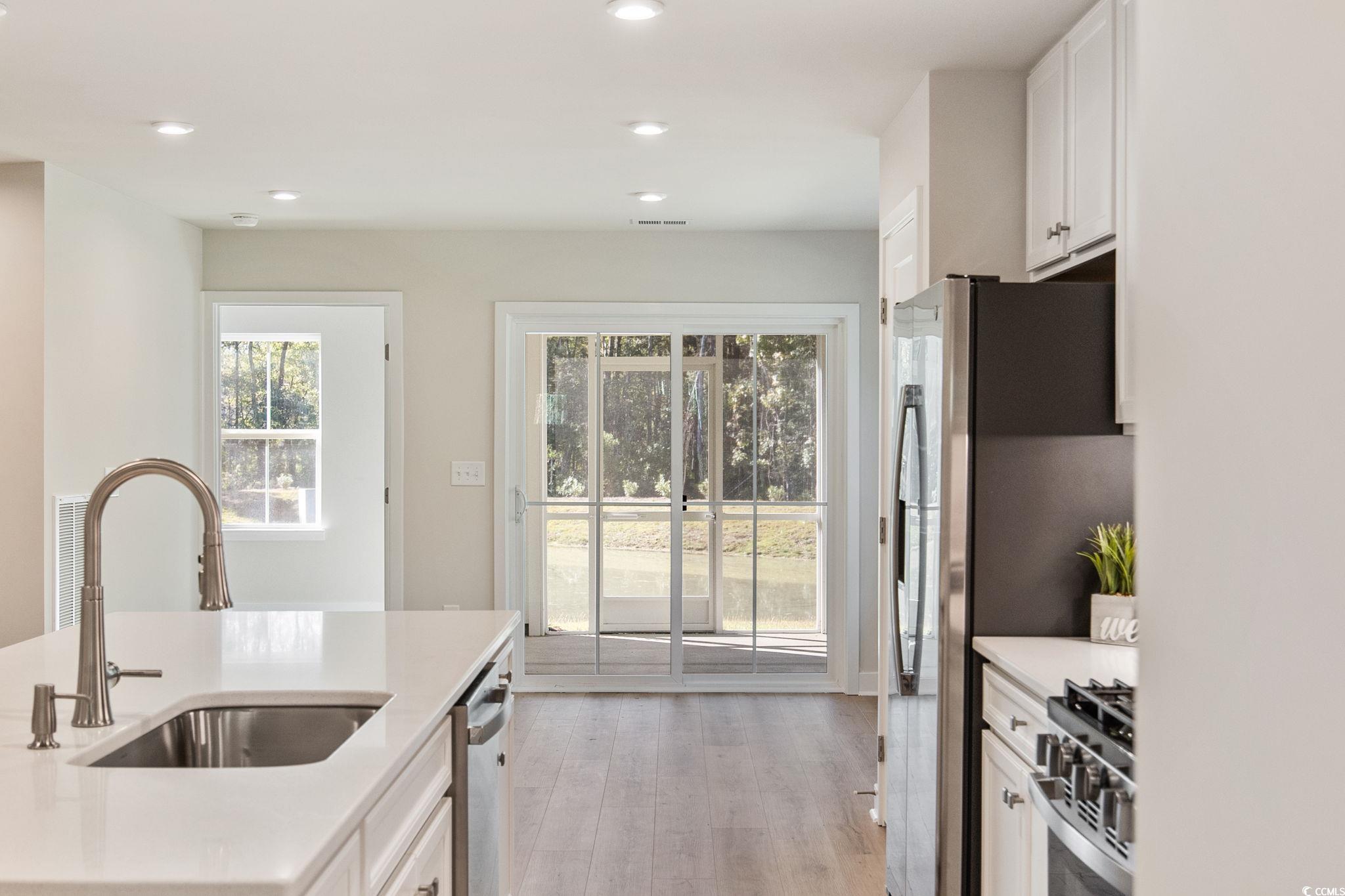 345 Bent Green, Unit 90A Murrells Inlet, SC 29576 - Photo 12 of 39 Kitchen featuring white cabinets, stainless steel appliances, light wood-style flooring, recessed lighting, and light stone counters