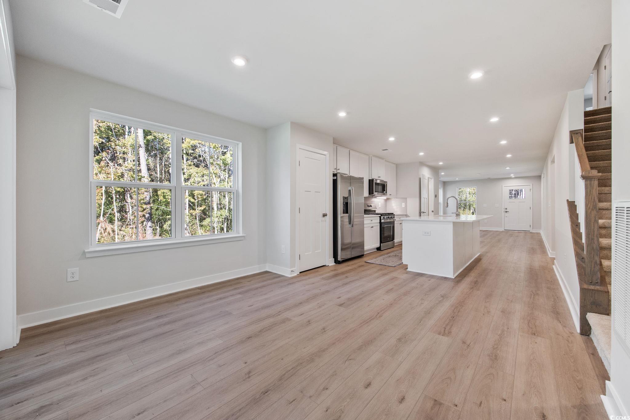 345 Bent Green, Unit 90A Murrells Inlet, SC 29576 - Photo 39 of 39 Kitchen featuring an island with sink, white cabinets, open floor plan, recessed lighting, and light wood finished floors