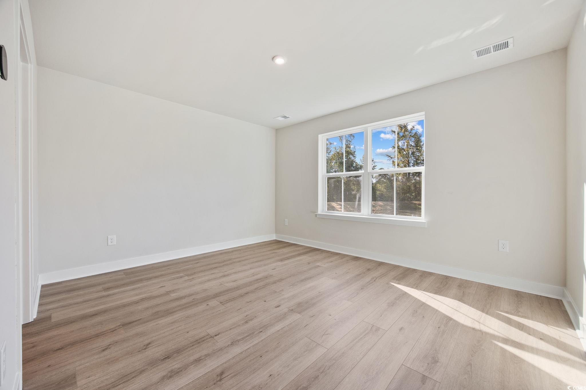 345 Bent Green, Unit 90A Murrells Inlet, SC 29576 - Photo 17 of 39 Empty room with light wood-style flooring and recessed lighting