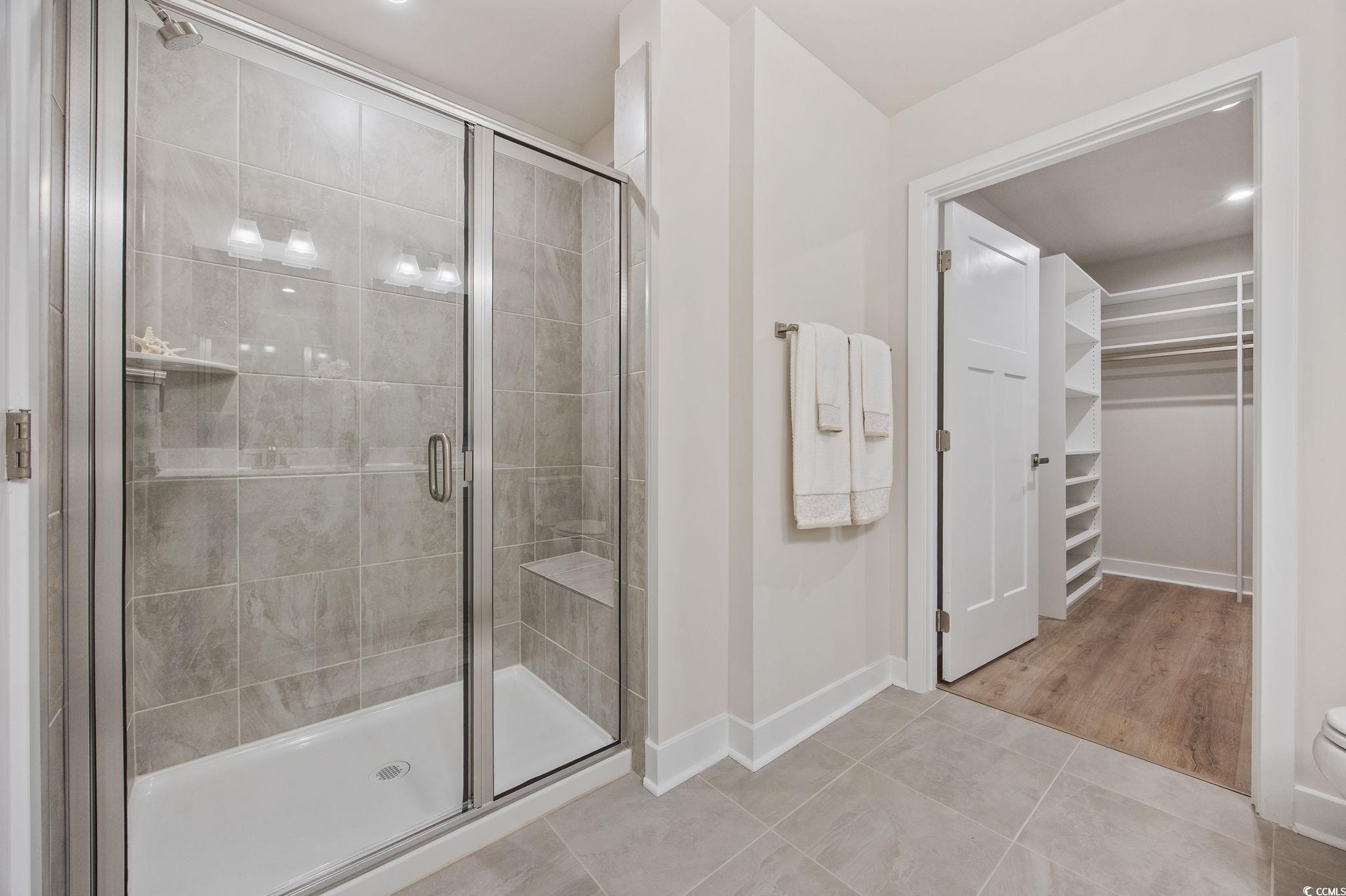 345 Bent Green, Unit 90A Murrells Inlet, SC 29576 - Photo 19 of 39 Full bathroom with a walk in closet, a shower stall, light tile patterned flooring, and recessed lighting