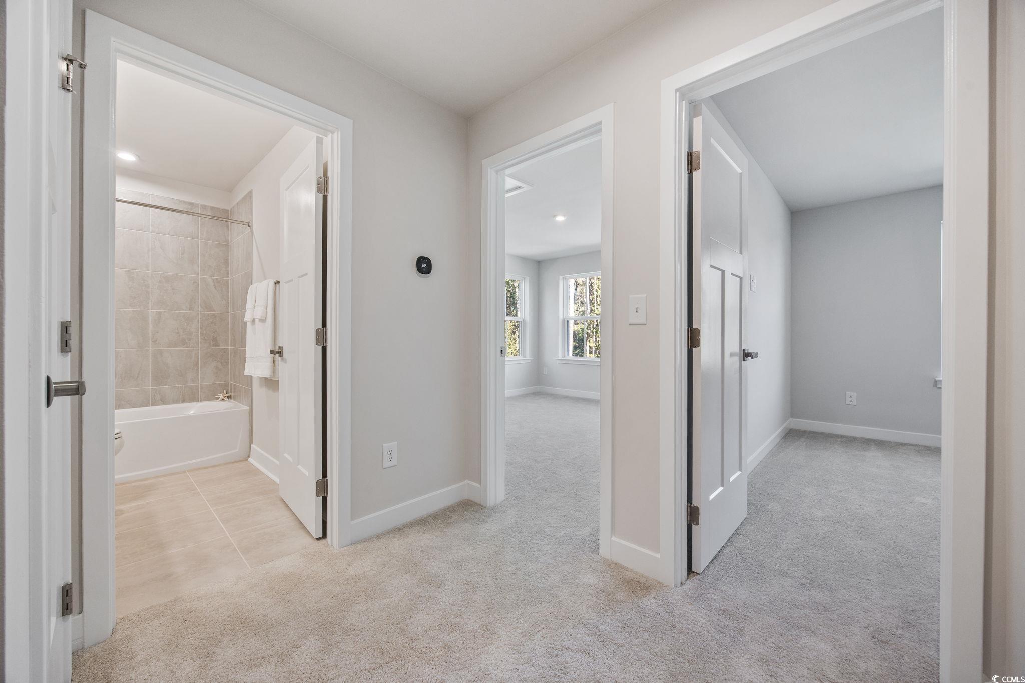 345 Bent Green, Unit 90A Murrells Inlet, SC 29576 - Photo 23 of 39 Hallway featuring light colored carpet and light tile patterned flooring