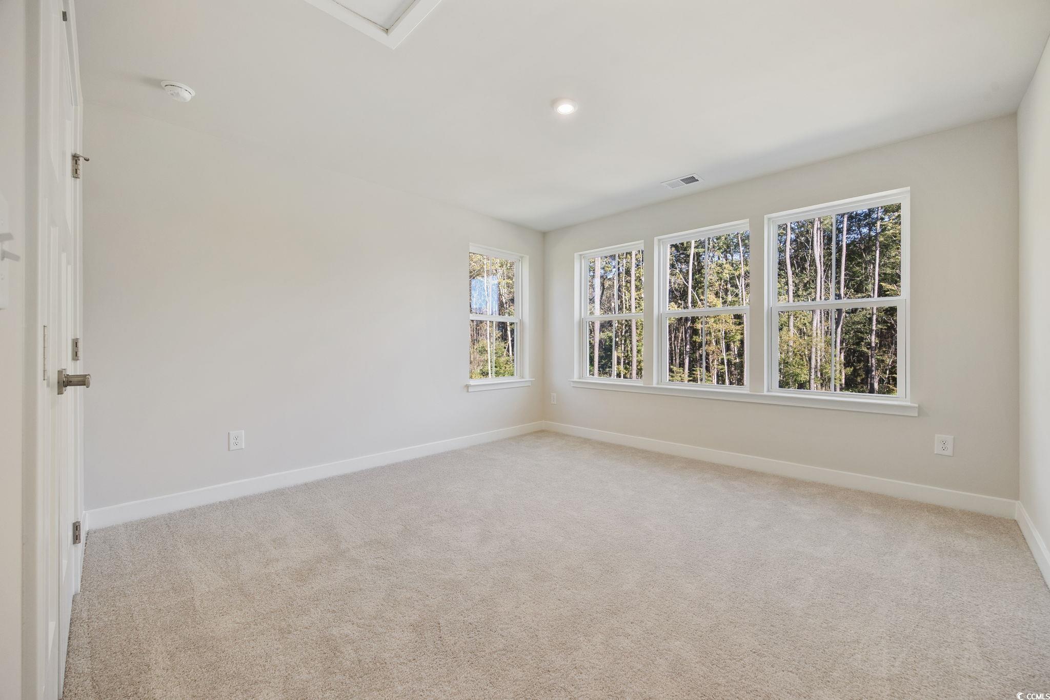 345 Bent Green, Unit 90A Murrells Inlet, SC 29576 - Photo 24 of 39 Empty room with light carpet and recessed lighting
