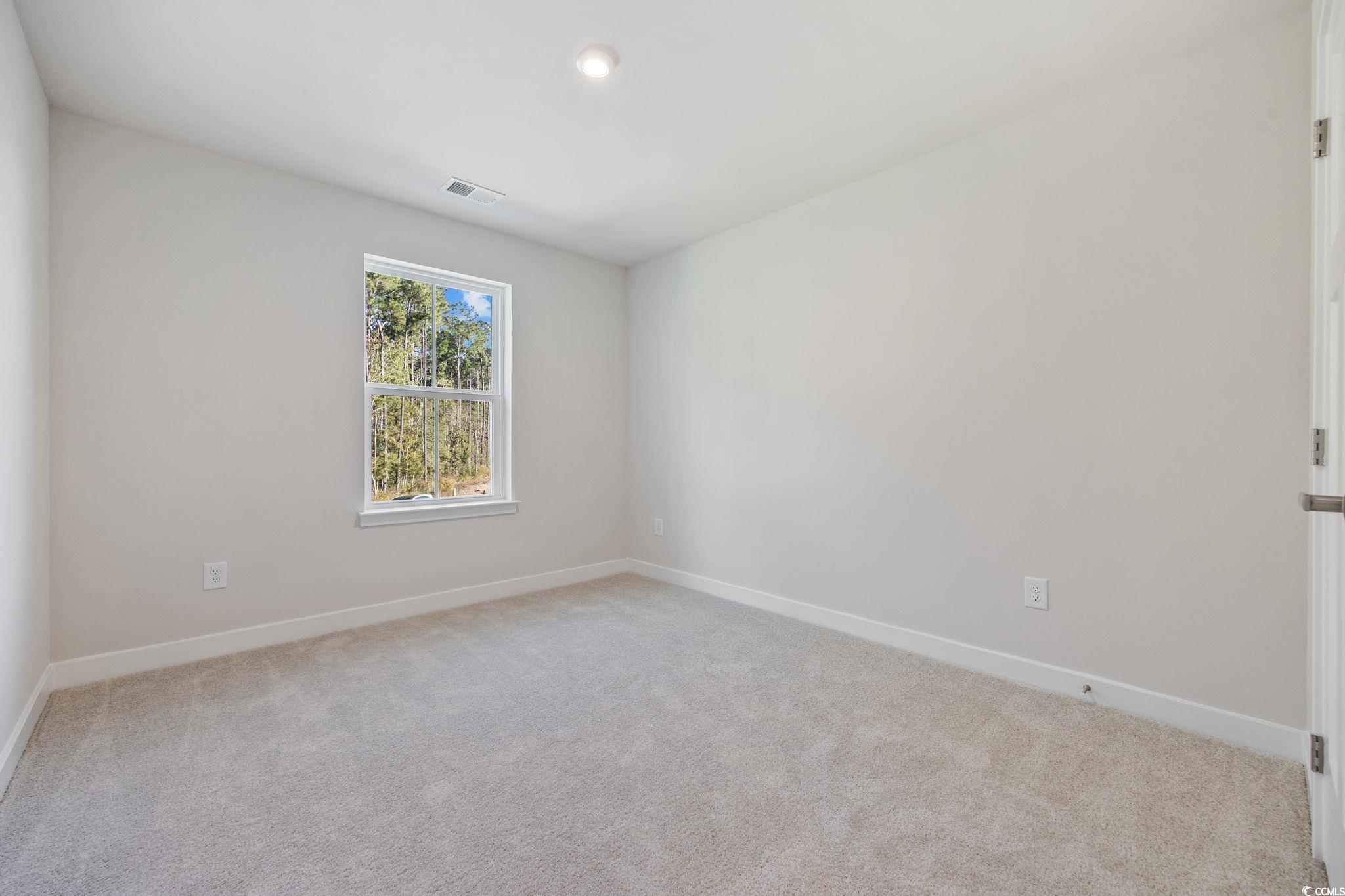 345 Bent Green, Unit 90A Murrells Inlet, SC 29576 - Photo 27 of 39 Empty room with light colored carpet and recessed lighting