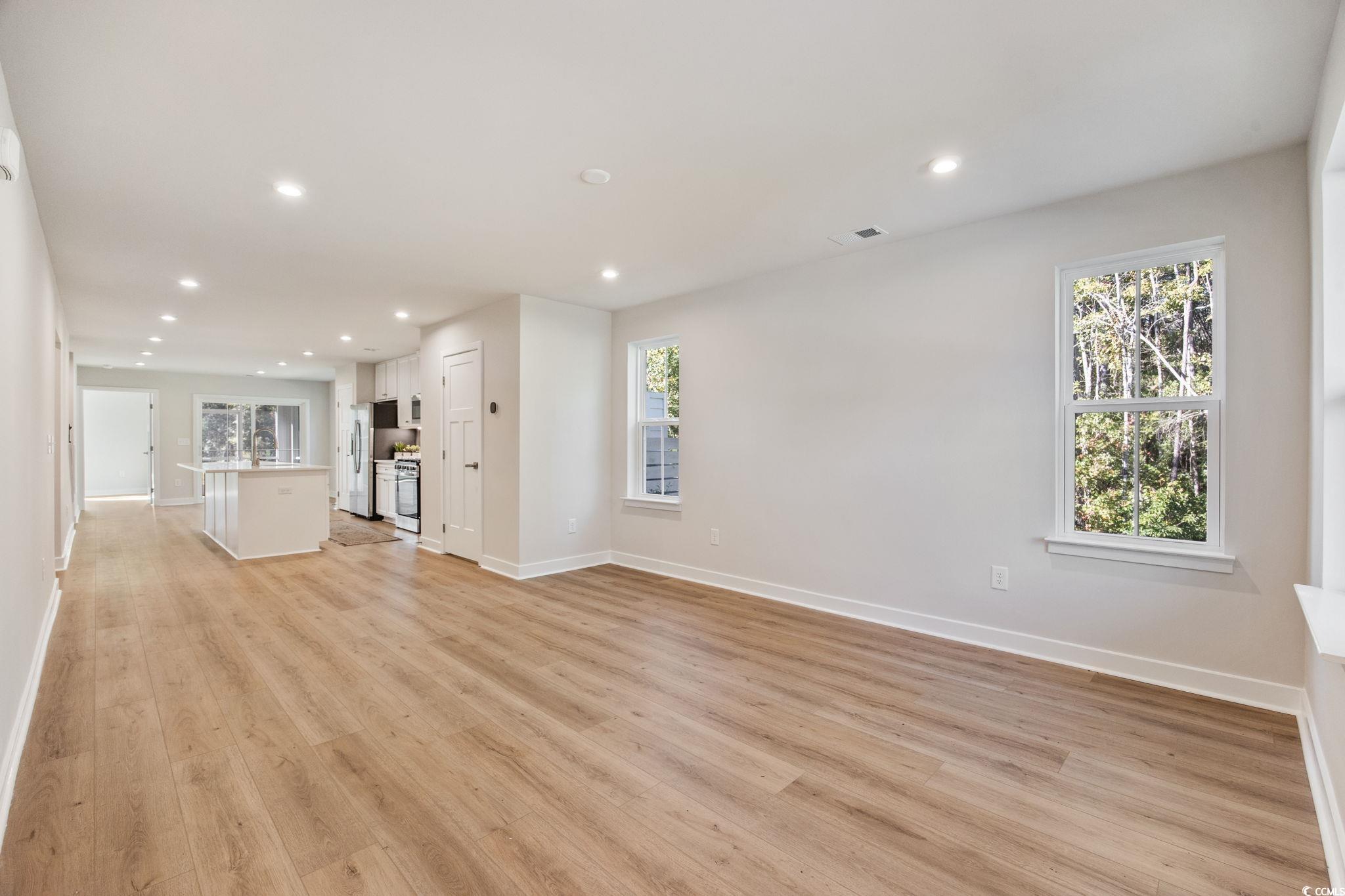 345 Bent Green, Unit 90A Murrells Inlet, SC 29576 - Photo 3 of 39 Unfurnished living room featuring recessed lighting and light wood-type flooring