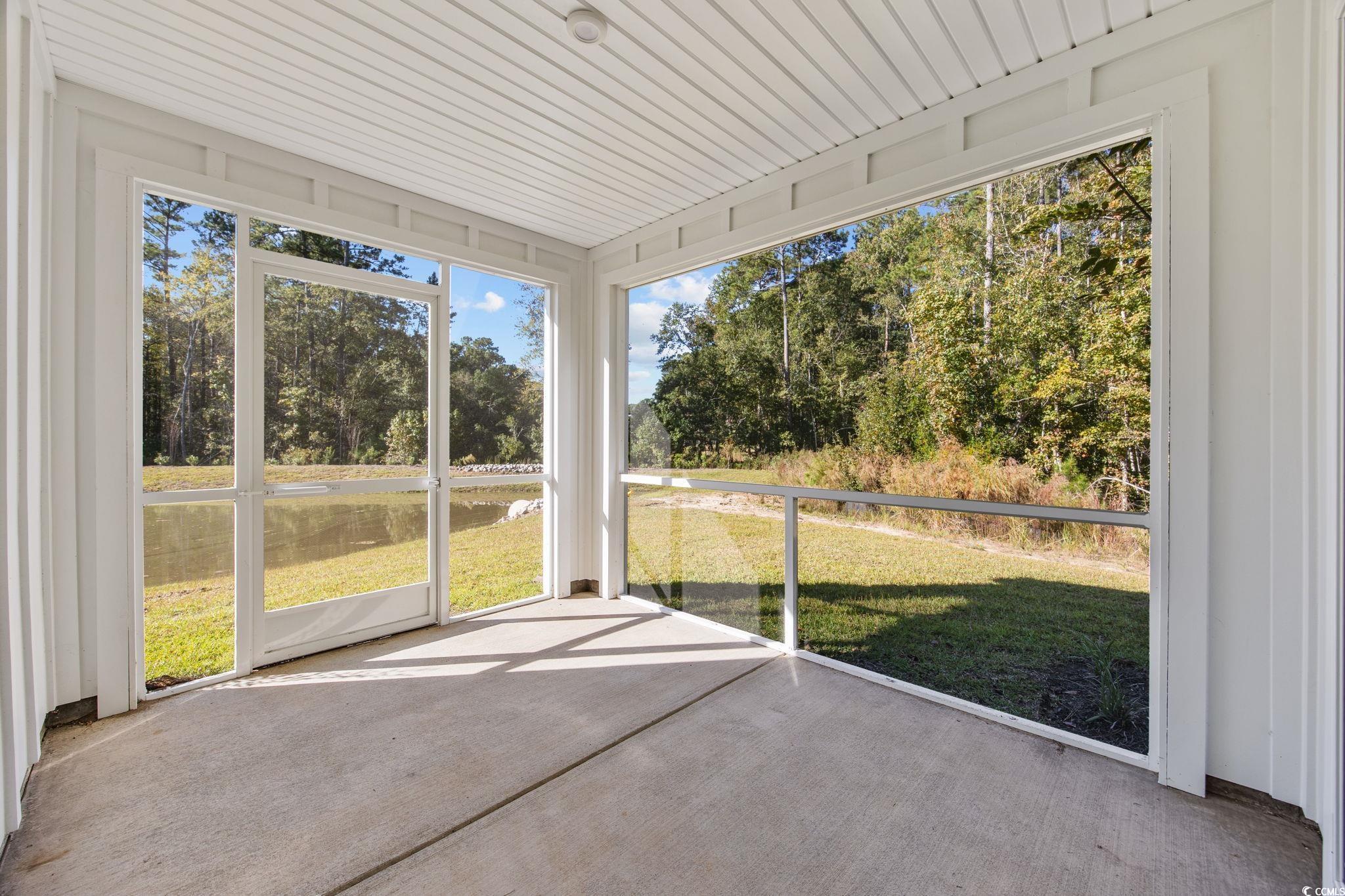 345 Bent Green, Unit 90A Murrells Inlet, SC 29576 - Photo 31 of 39 Unfurnished sunroom featuring a water view and view of wooded area