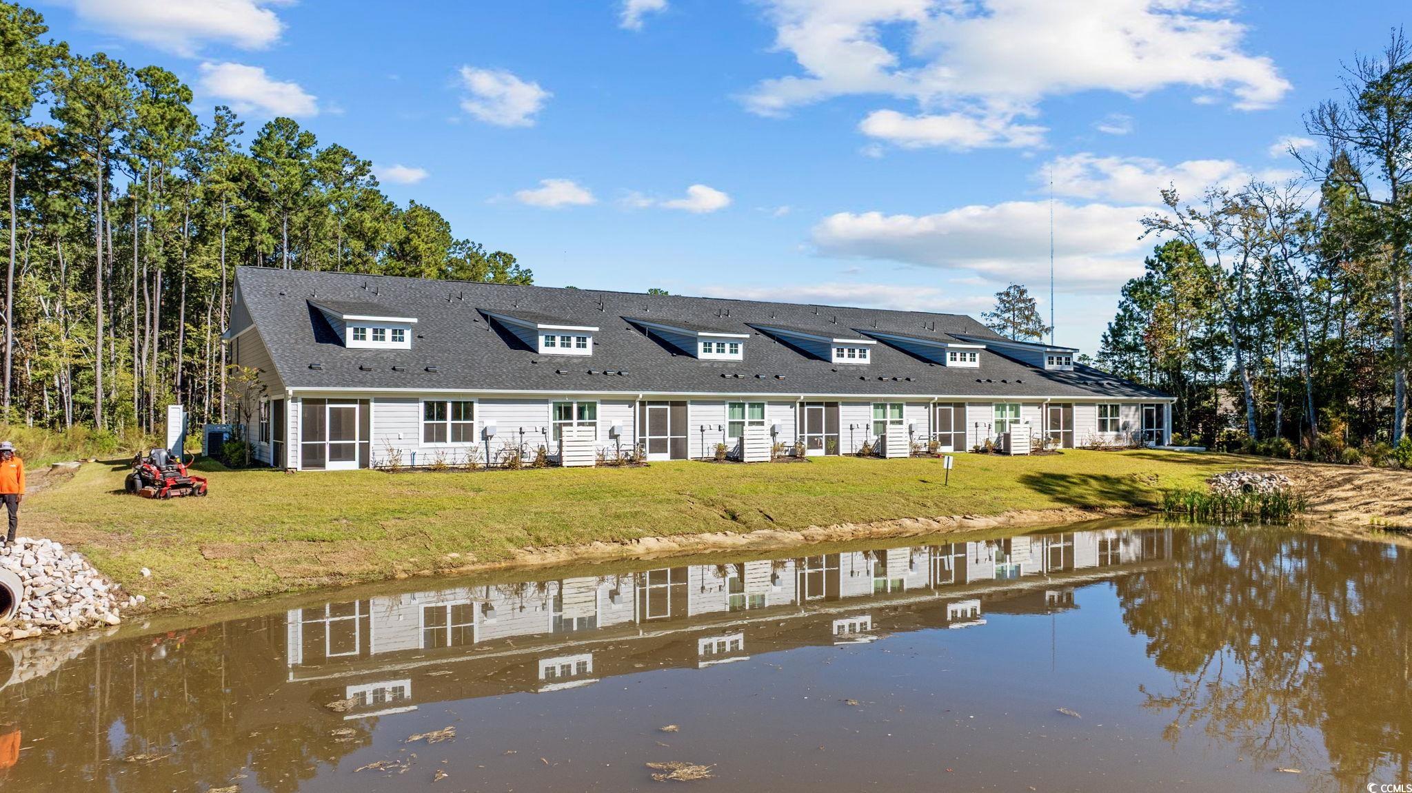 345 Bent Green, Unit 90A Murrells Inlet, SC 29576 - Photo 35 of 39 Rear view of property featuring a water view and a yard