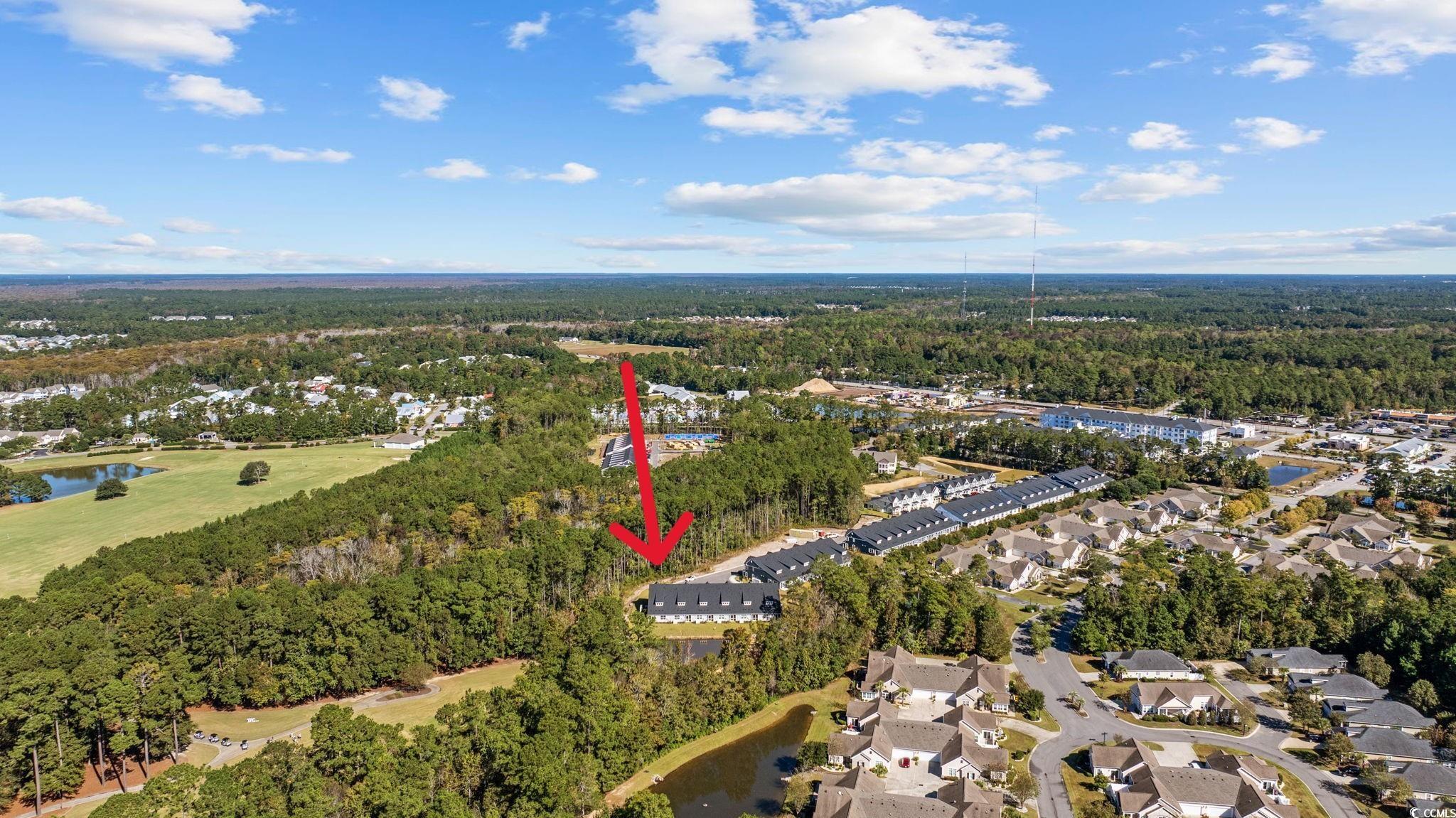 345 Bent Green, Unit 90A Murrells Inlet, SC 29576 - Photo 38 of 39 Aerial overview of property's location with a large body of water and nearby suburban area