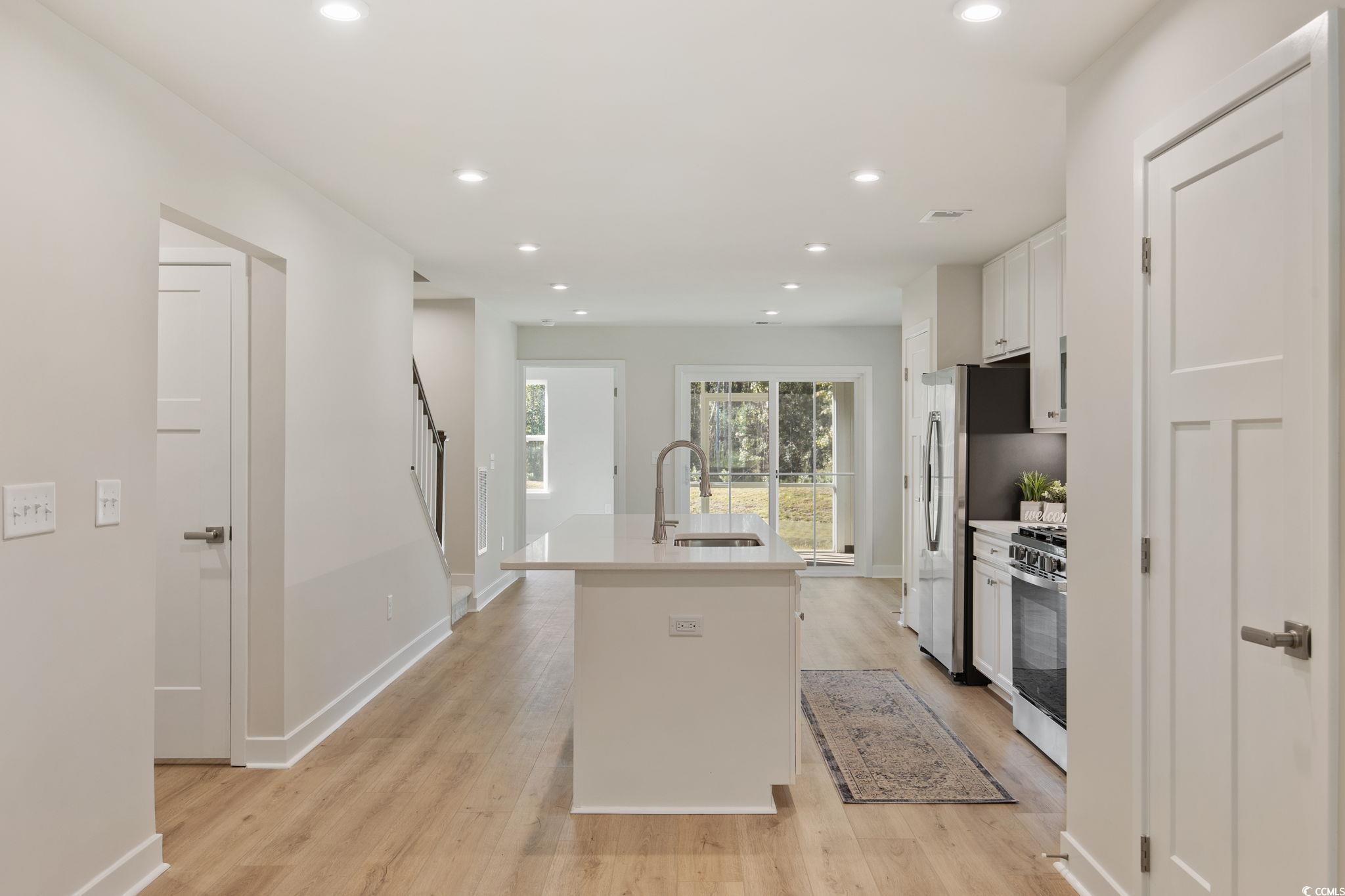 345 Bent Green, Unit 90A Murrells Inlet, SC 29576 - Photo 6 of 39 Kitchen featuring white cabinets, a center island with sink, recessed lighting, and light wood finished floors