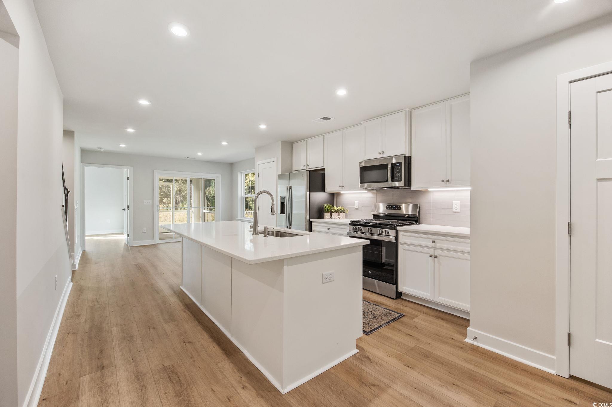 345 Bent Green, Unit 90A Murrells Inlet, SC 29576 - Photo 8 of 39 Kitchen featuring decorative backsplash, appliances with stainless steel finishes, an island with sink, white cabinetry, and recessed lighting