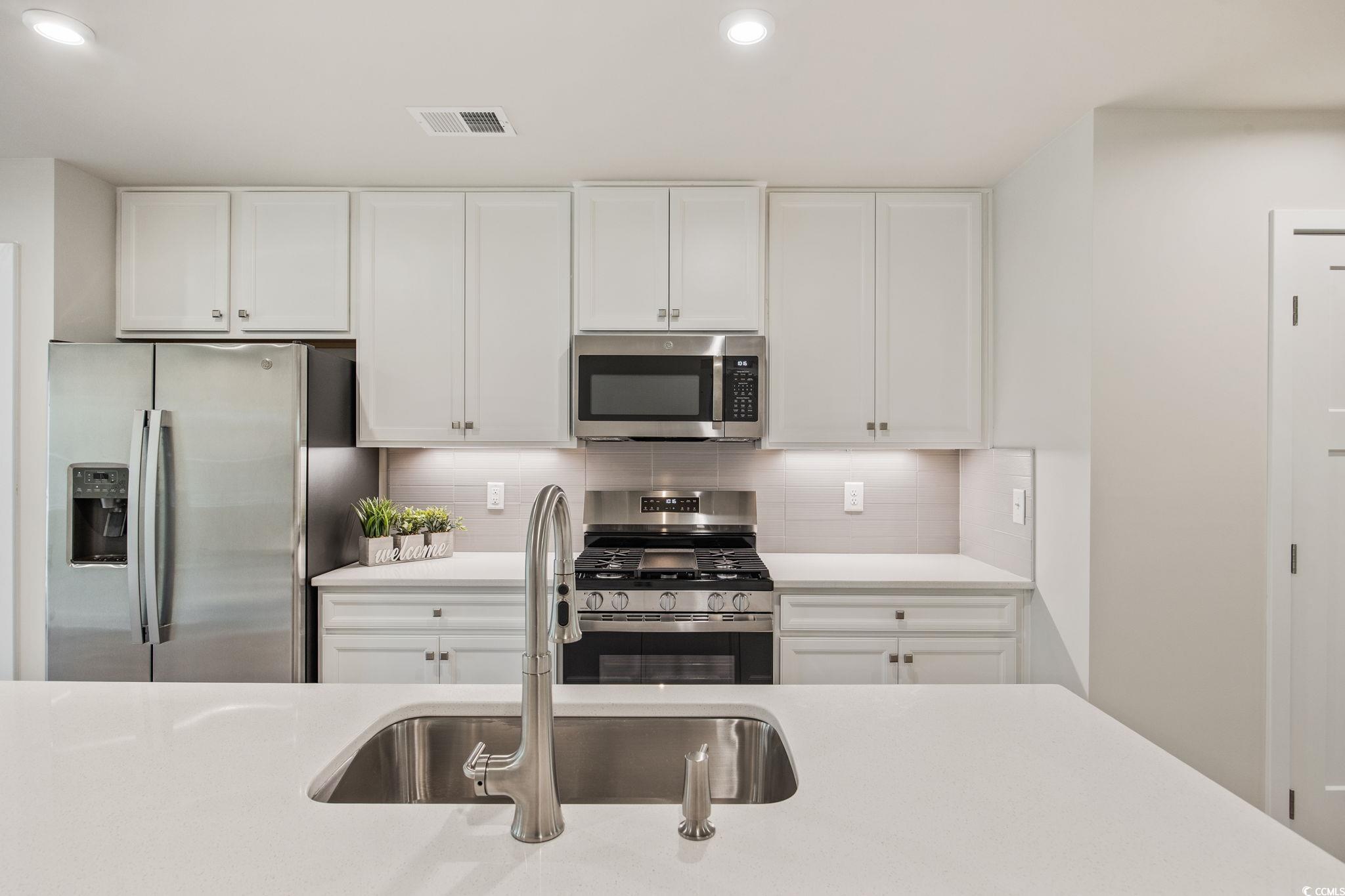 345 Bent Green, Unit 90A Murrells Inlet, SC 29576 - Photo 10 of 39 Kitchen with stainless steel appliances, white cabinets, tasteful backsplash, and recessed lighting