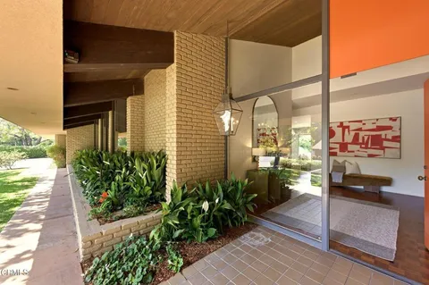 a view of a path along with potted plants