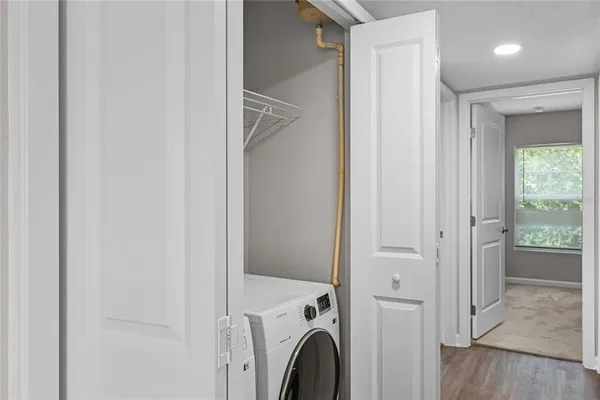 a view of a hallway with washer and dryer