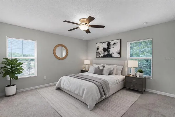a bedroom with a large bed and a chandelier