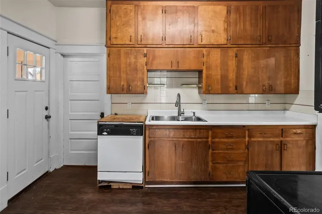 a kitchen with stainless steel appliances granite countertop a sink and a stove