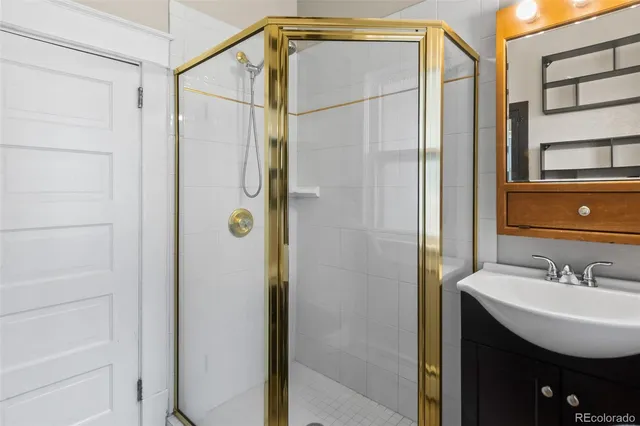 a bathroom with a shower and a sink