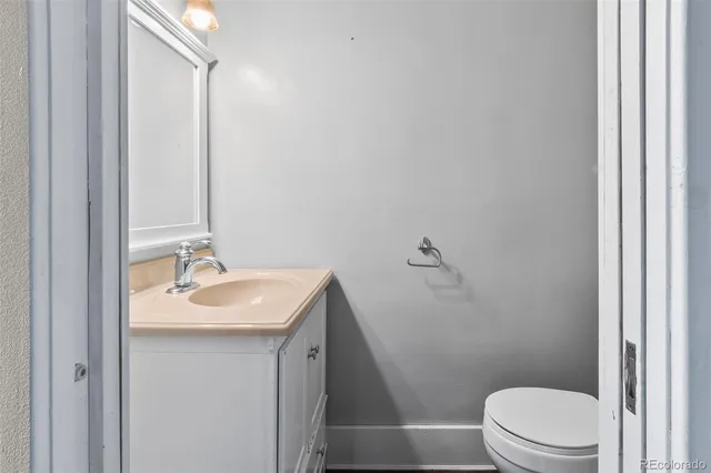 a bathroom with a sink toilet and a mirror
